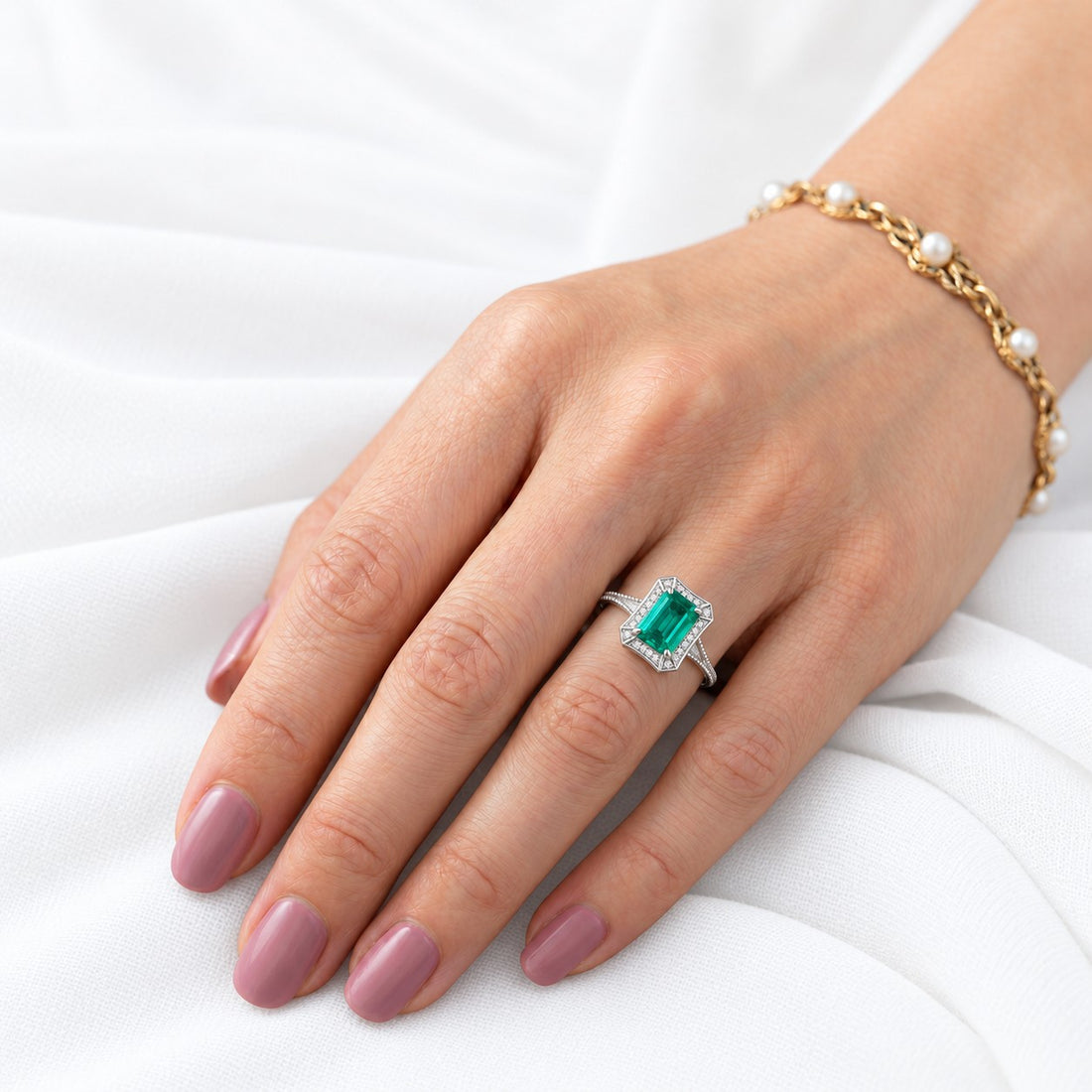 The Deco Empress — Emerald Halo Ring in 14K white gold, on the hand