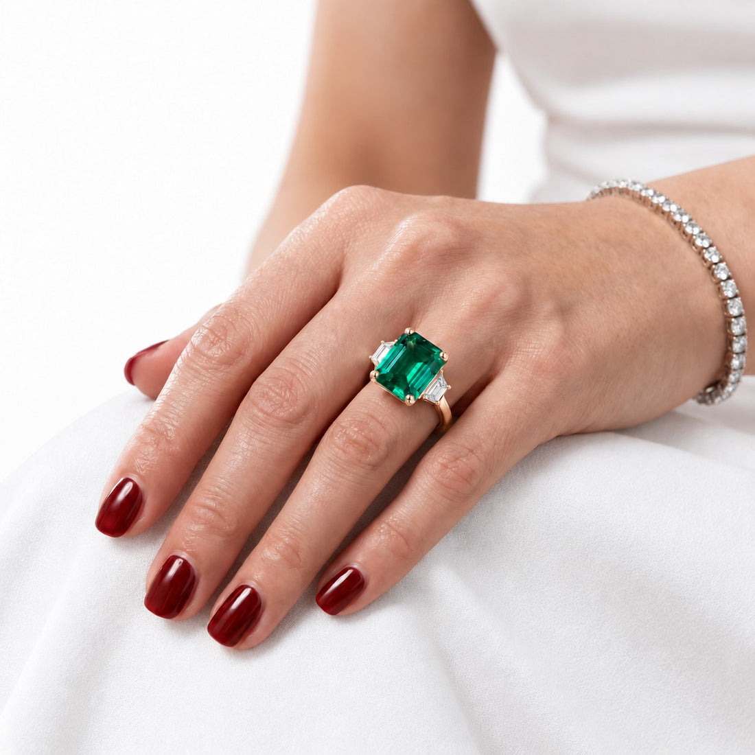 The Meridian — Emerald Three-Stone Ring in 14K rose gold, on the hand