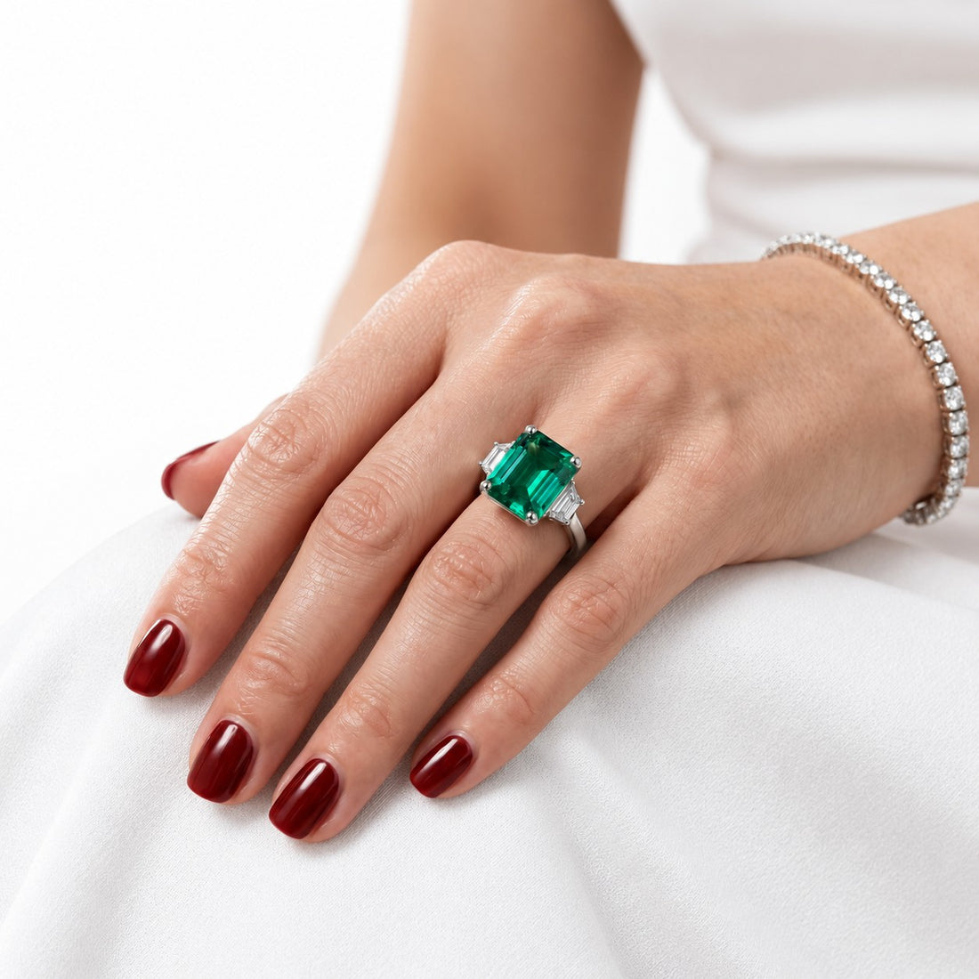 The Meridian — Emerald Three-Stone Ring in 14K white gold, on the hand