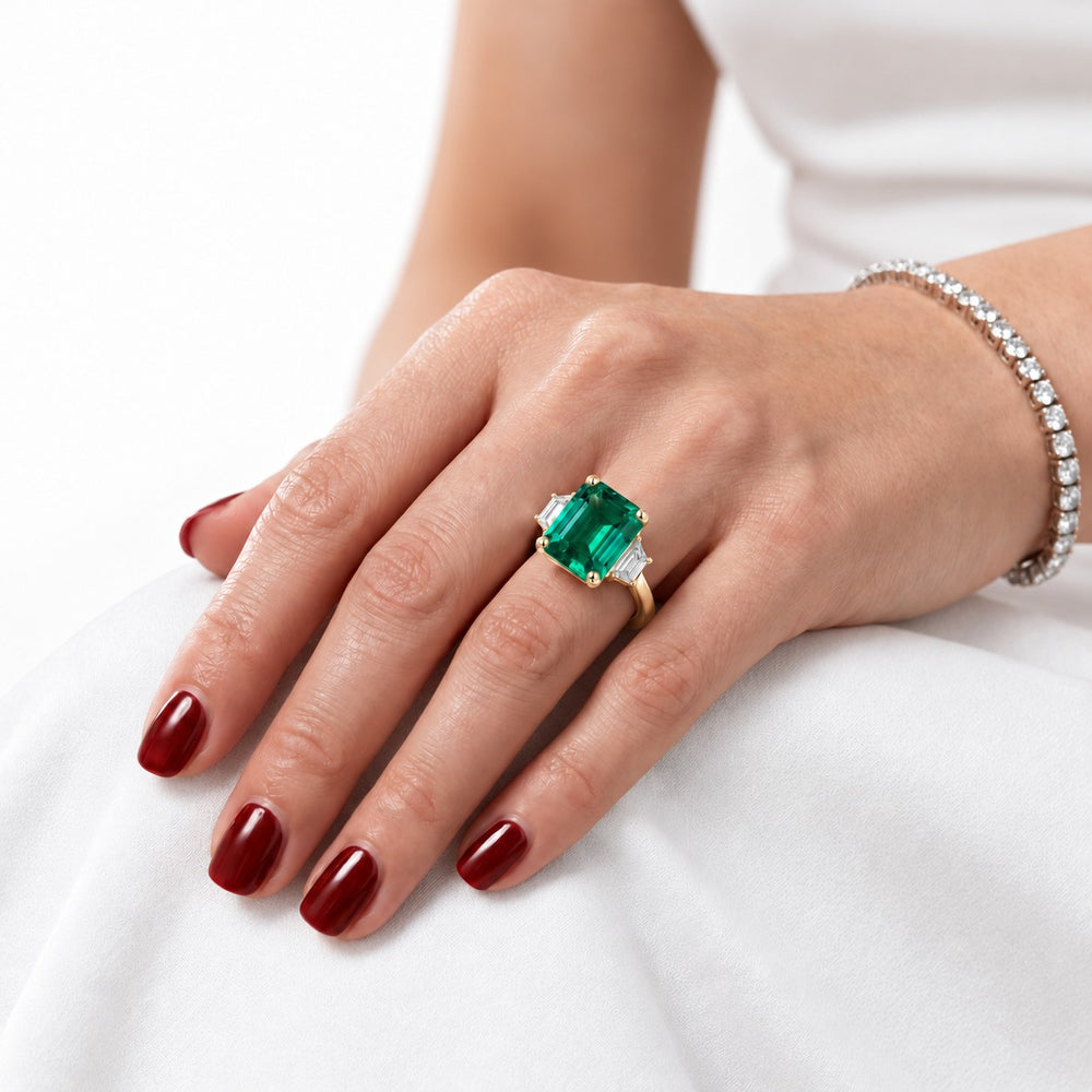 The Meridian — Emerald Three-Stone Ring in 14K yellow gold, on the hand