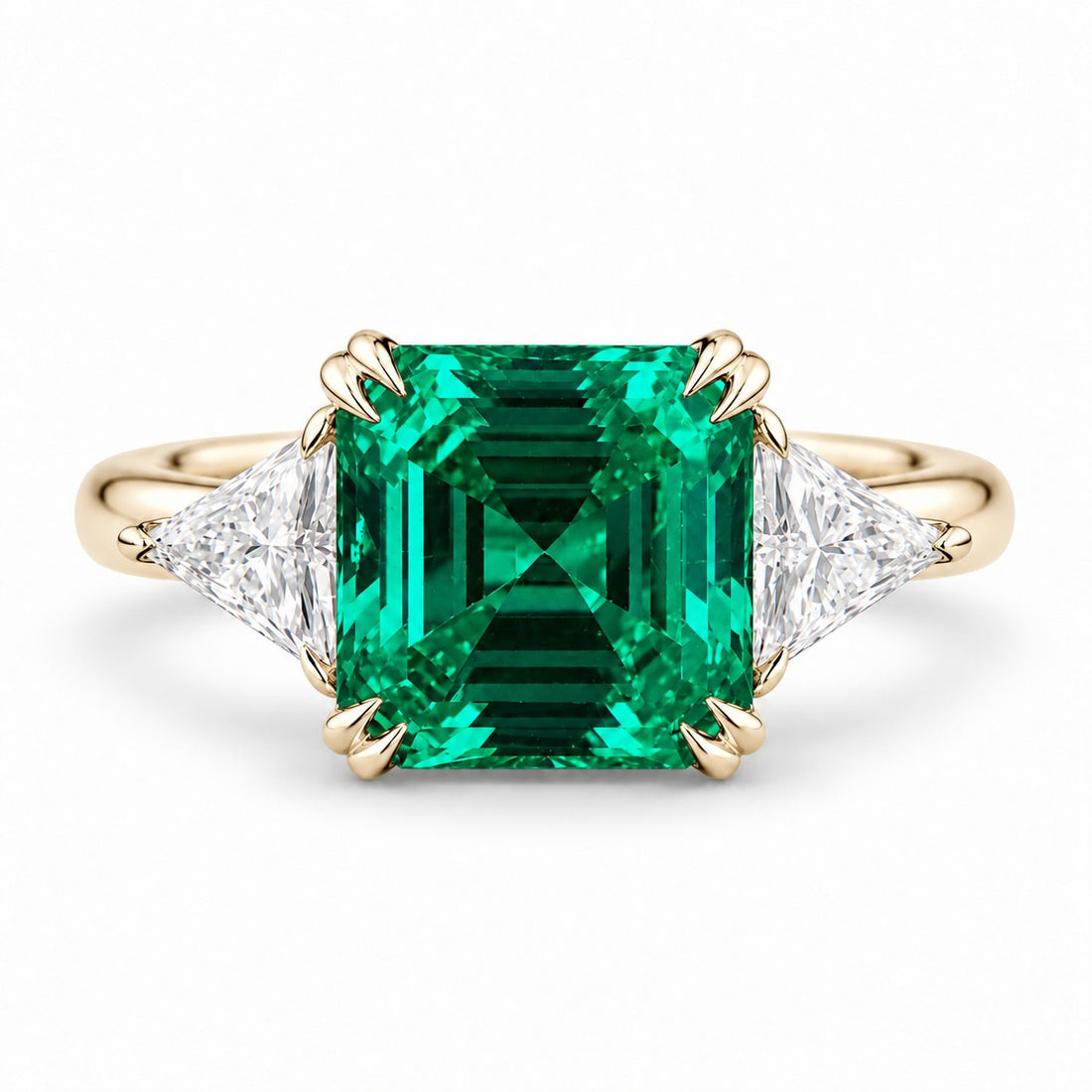 The Facet — Emerald Three-Stone Ring in 14K yellow gold, front view