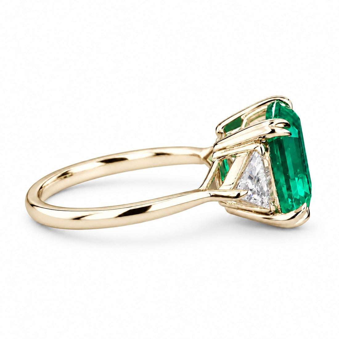 The Facet — Emerald Three-Stone Ring in 14K yellow gold, side view