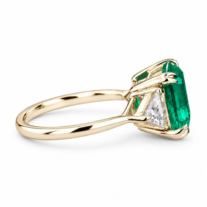 The Facet — Emerald Three-Stone Ring in 14K yellow gold, side view