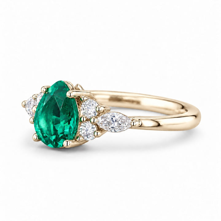The Dew — Pear Emerald Ring in 14K yellow gold, three-quarter view