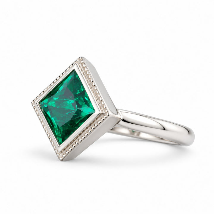 The Compass — Milgrain Bezel Emerald Ring in 14K white gold, three-quarter view