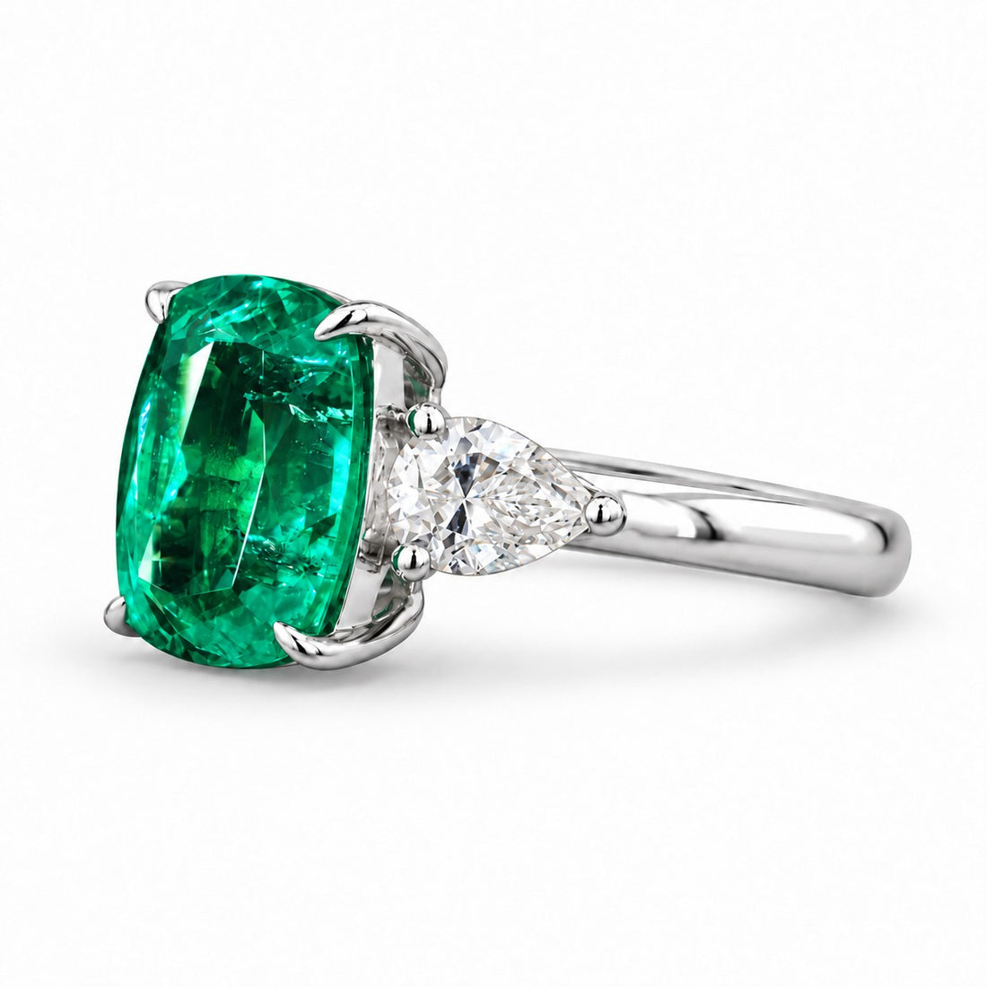 The Elysian — Cushion Three-Stone Emerald Ring in 14K white gold, three-quarter view