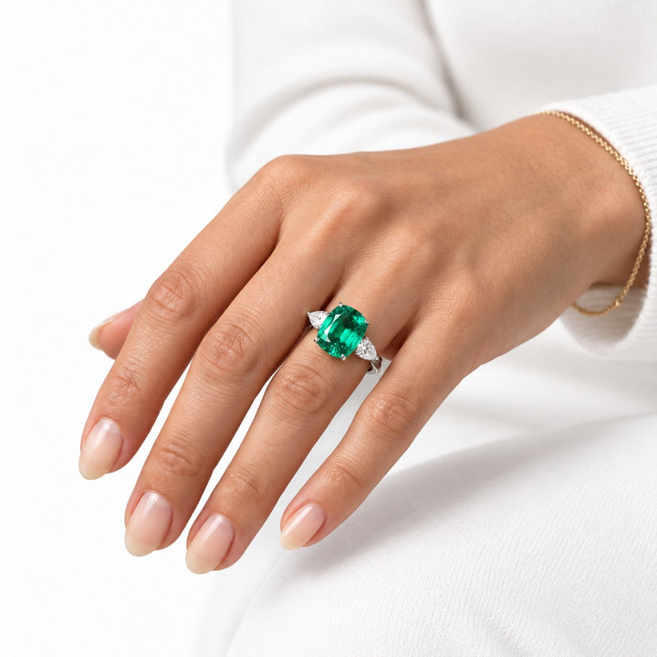 The Elysian — Cushion Three-Stone Emerald Ring in 14K white gold, on the hand