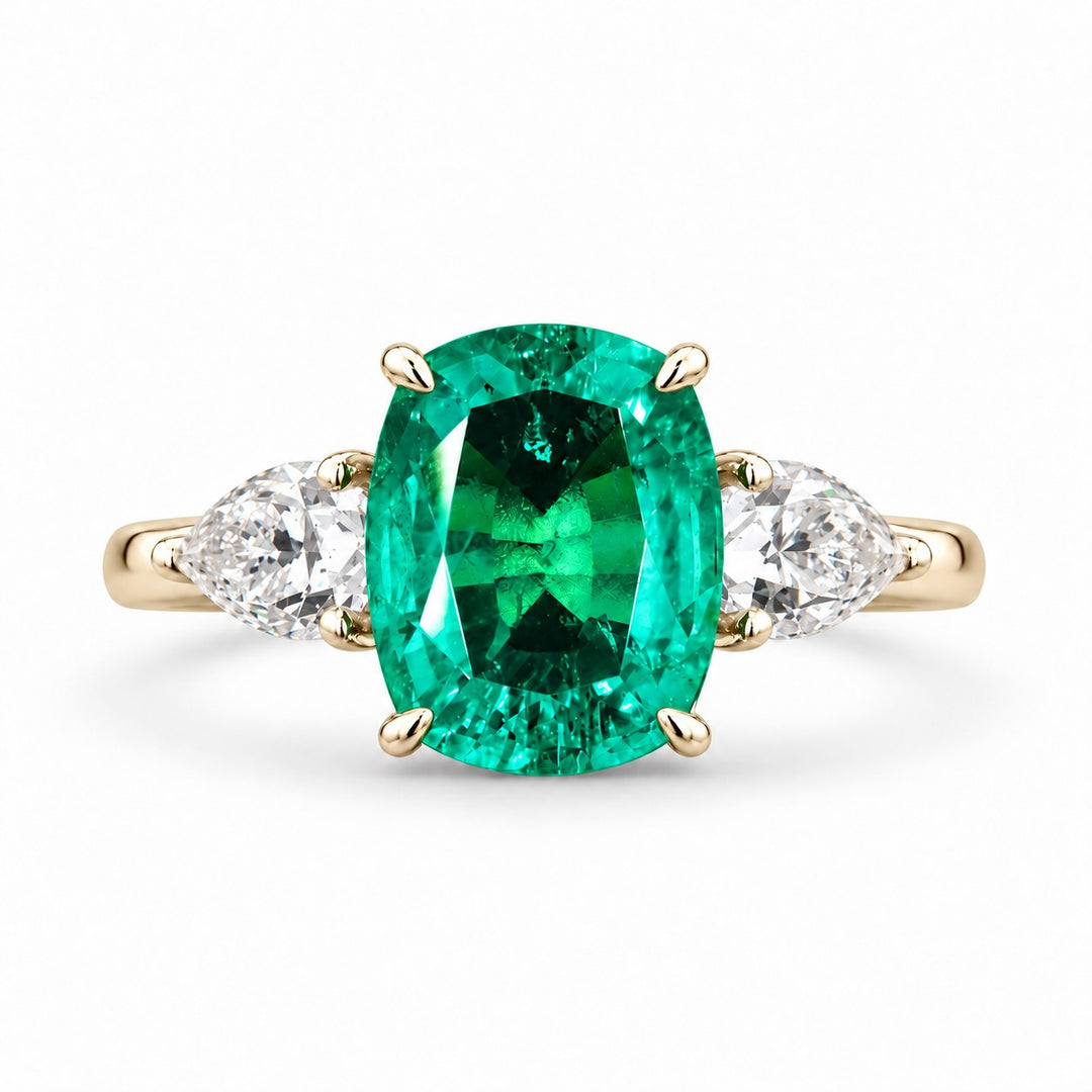 The Elysian — Cushion Three-Stone Emerald Ring in 14K yellow gold, front view