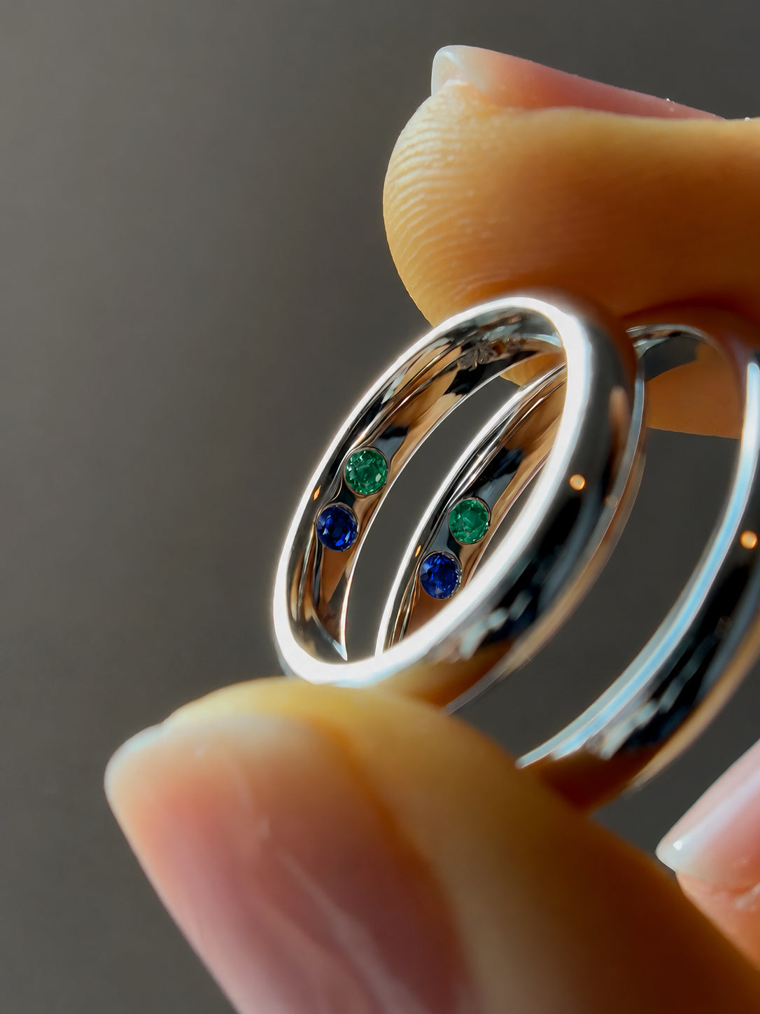 Two birthstone inlay bands: emerald and sapphire