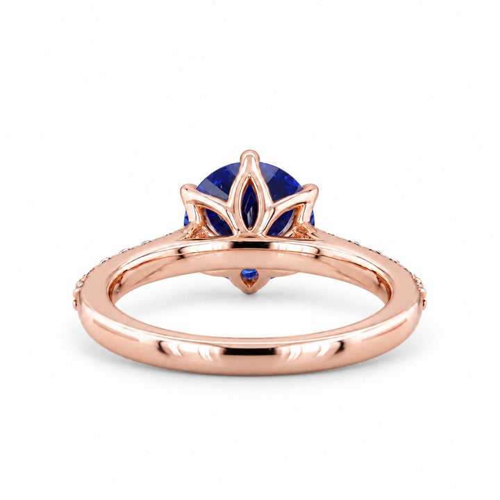 The Bluebell — Blue Round Sapphire with Floral Prongs & Diamond Half-Eternity Ring in rose gold, profile view