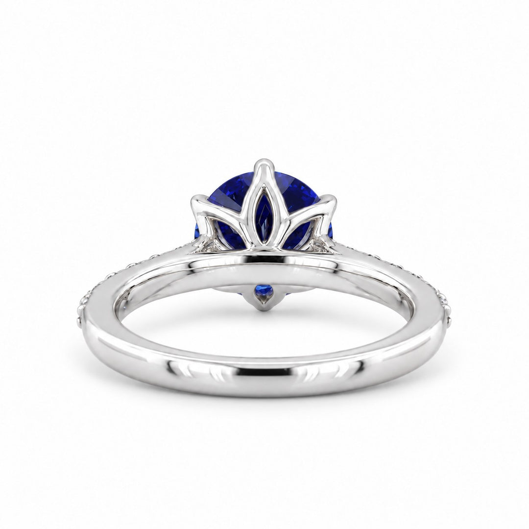 The Bluebell — Blue Round Sapphire with Floral Prongs & Diamond Half-Eternity Ring in white gold, profile view