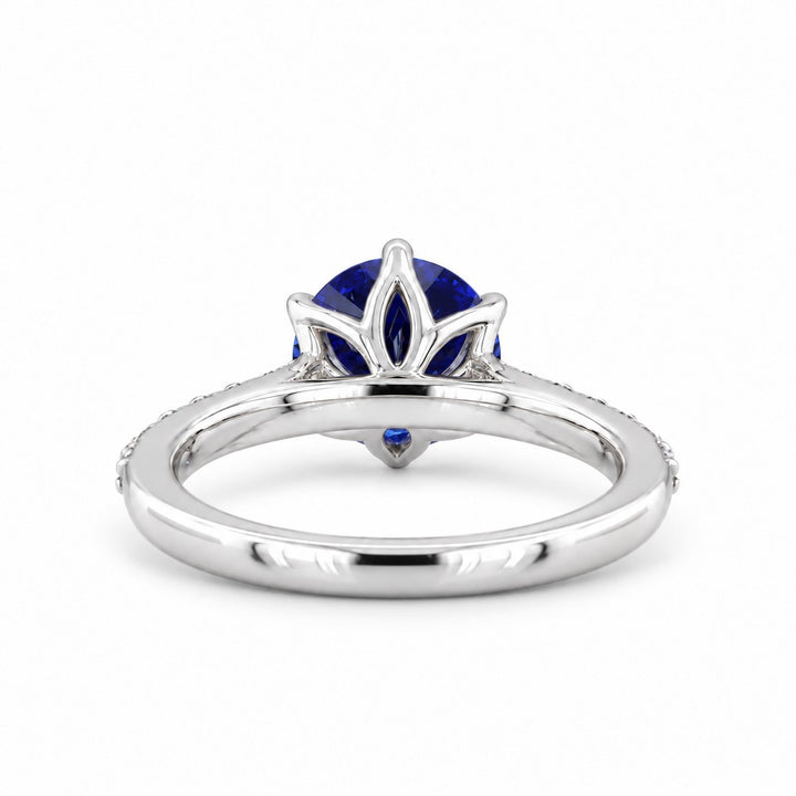 The Bluebell — Blue Round Sapphire with Floral Prongs & Diamond Half-Eternity Ring in white gold, profile view