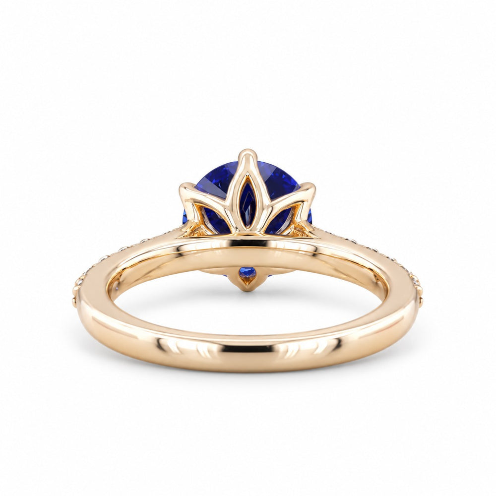 The Bluebell — Blue Round Sapphire with Floral Prongs & Diamond Half-Eternity Ring in yellow gold, profile view