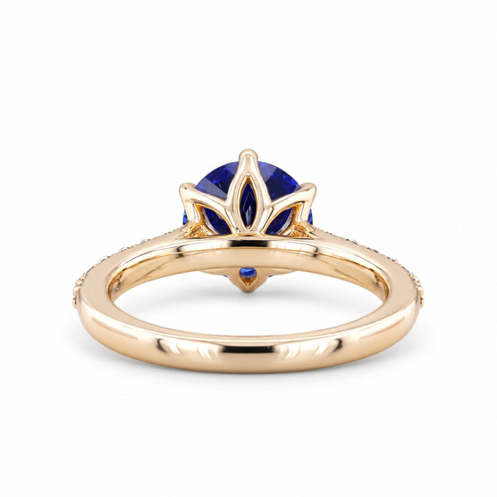 The Bluebell — Blue Round Sapphire with Floral Prongs & Diamond Half-Eternity Ring in yellow gold, profile view