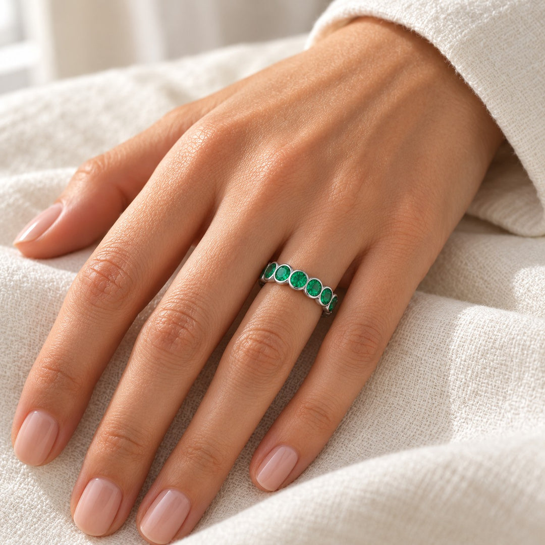 Round Colombian Emerald Bezel-Set Eternity Band (3.2mm, 1.50ctw) in white gold, on the hand
