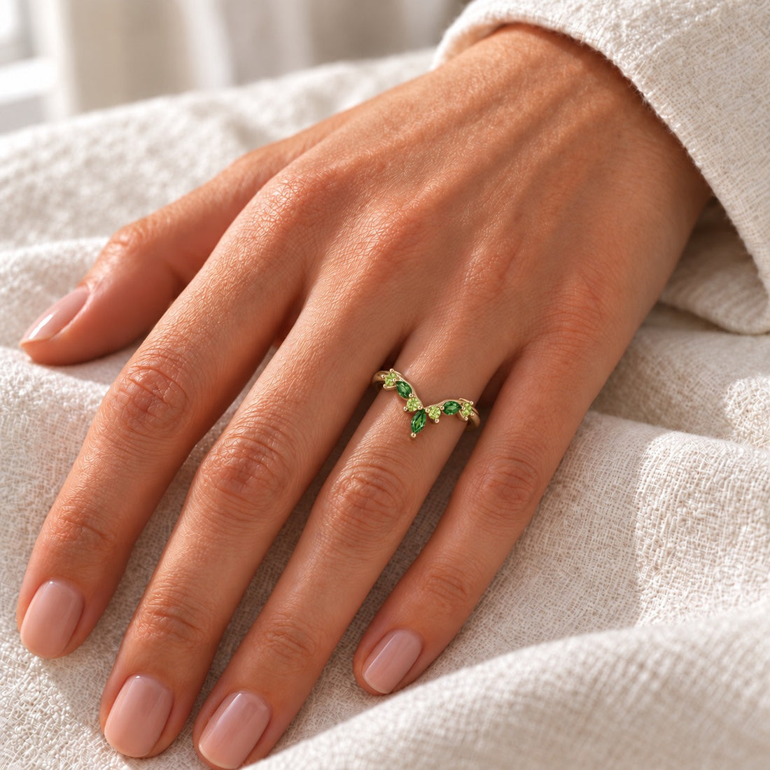 The Elowen — Emerald & Peridot Chevron Band in yellow gold, on the hand