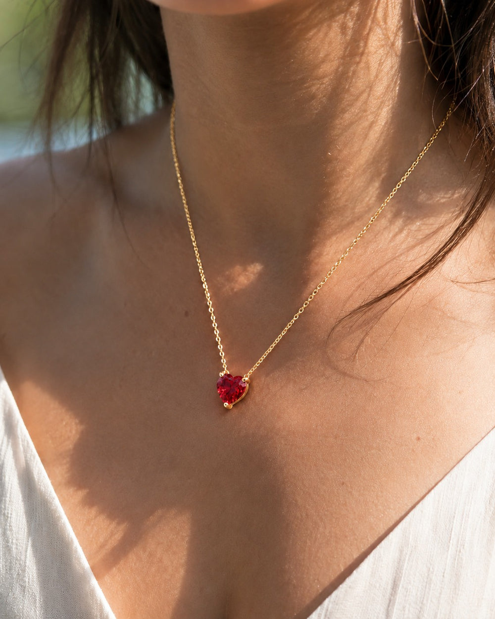 Three-Prong Heart Lab Ruby Pendant — 10mm worn on model in 14K Yellow Gold