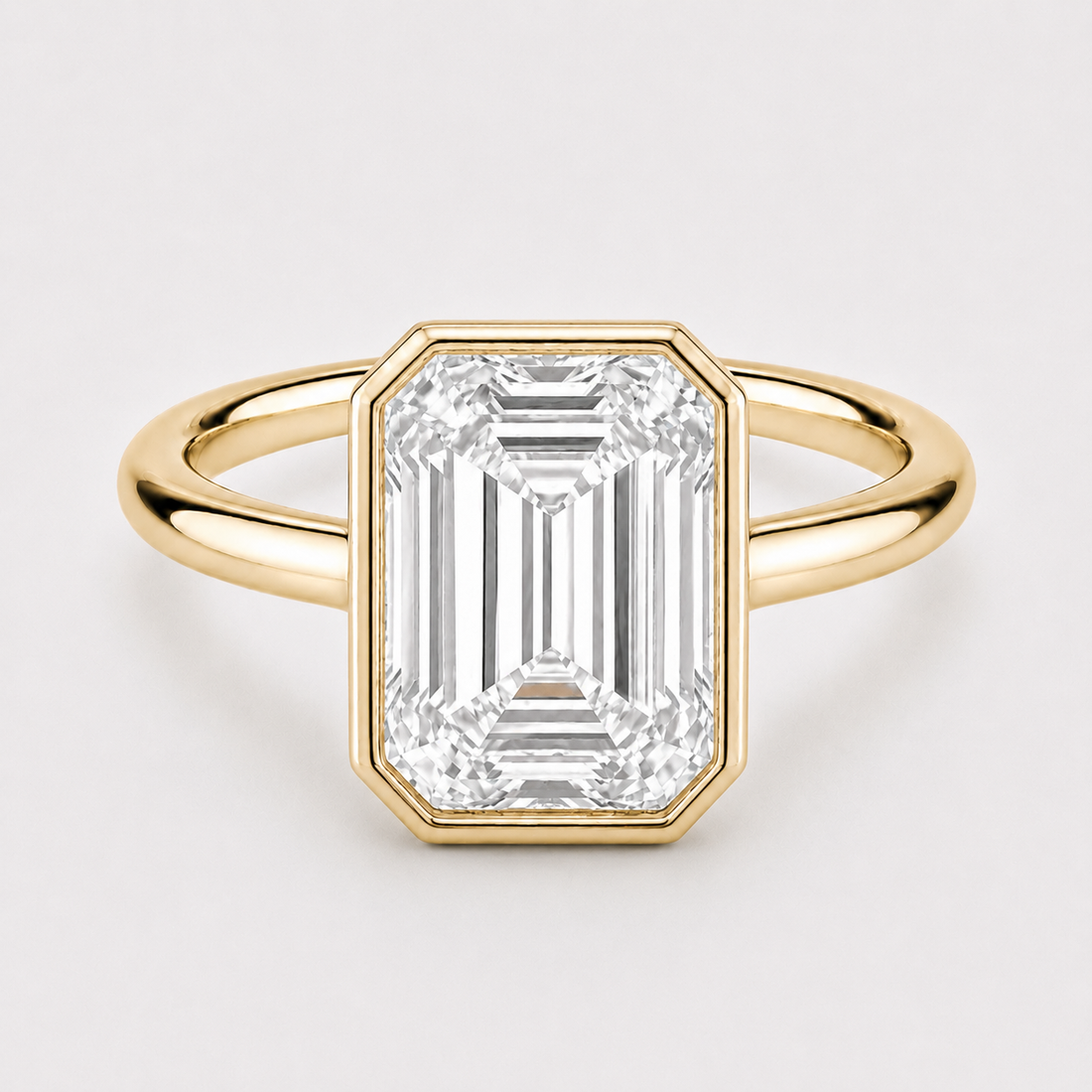 The Paragon emerald-cut lab diamond bezel ring in 14K yellow gold