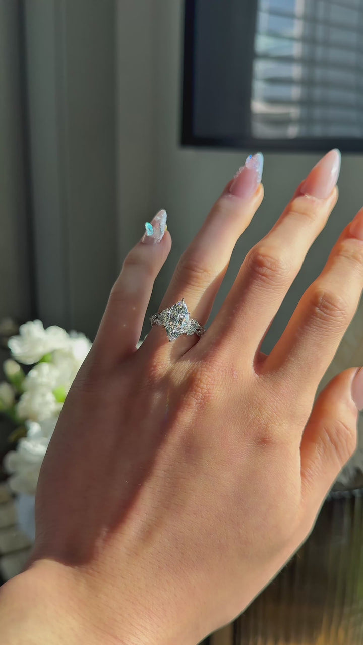 The Gardenia in 14K white gold — worn on the hand (far to close) [ld m=w shot=wear]