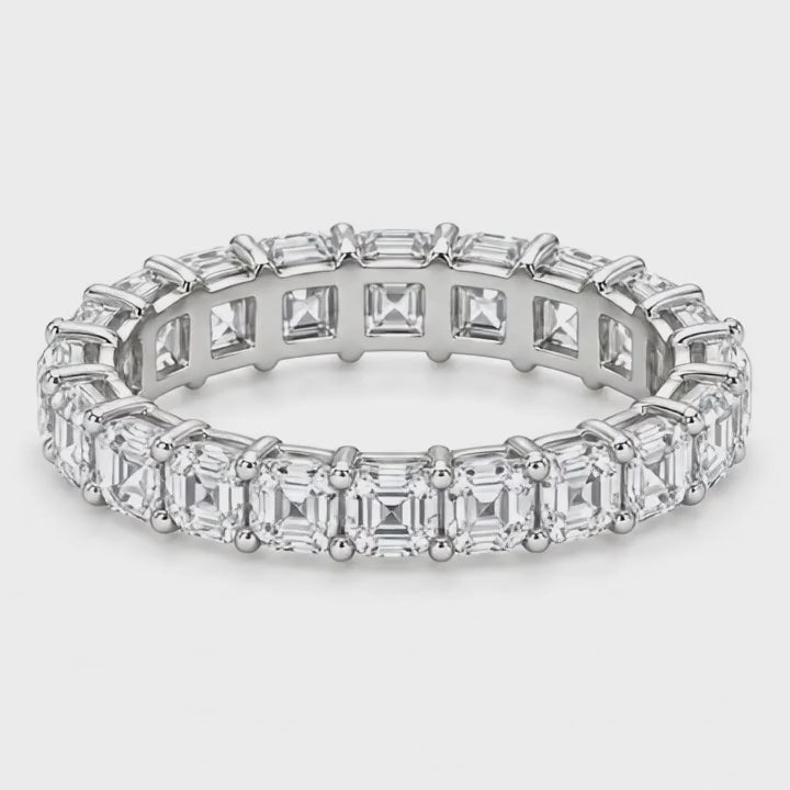 Asscher lab-grown diamond eternity band in white gold turning on a white background