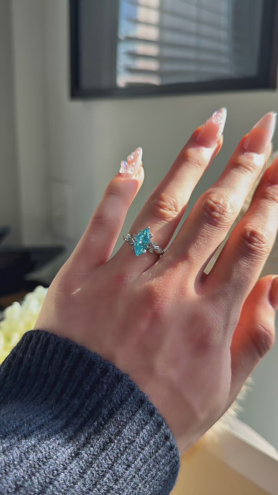 The Sovereign Crest blue diamond in 14K white gold — worn on the hand (far to close) [ld m=w shot=wear]