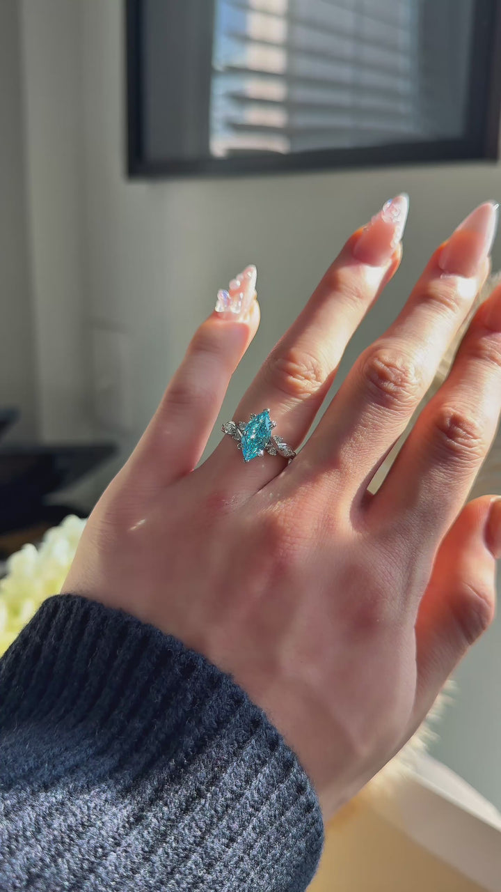 The Sovereign Crest blue diamond in 14K white gold — worn on the hand (far to close) [ld m=w shot=wear]
