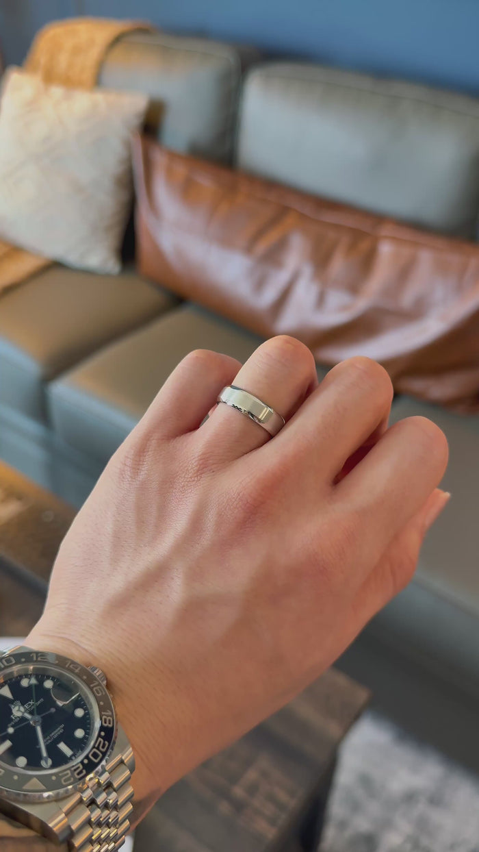 Brushed beveled platinum band — worn on the hand (far to close) [ld m=p shot=wear]