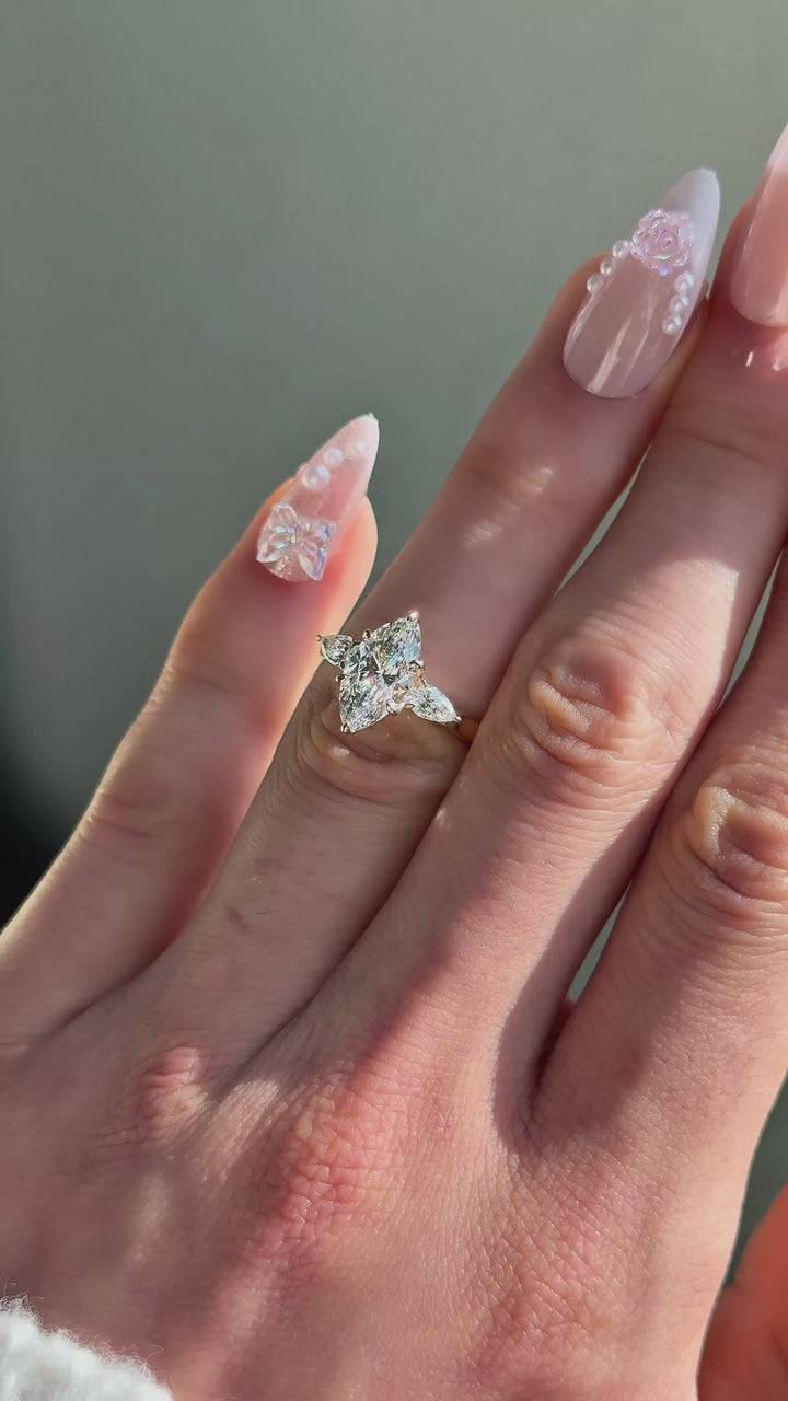 Lotus Lace Trilogy in 14K yellow gold, marquise look — worn on the hand (far to close) [ld m=y look=marquise shot=wear]