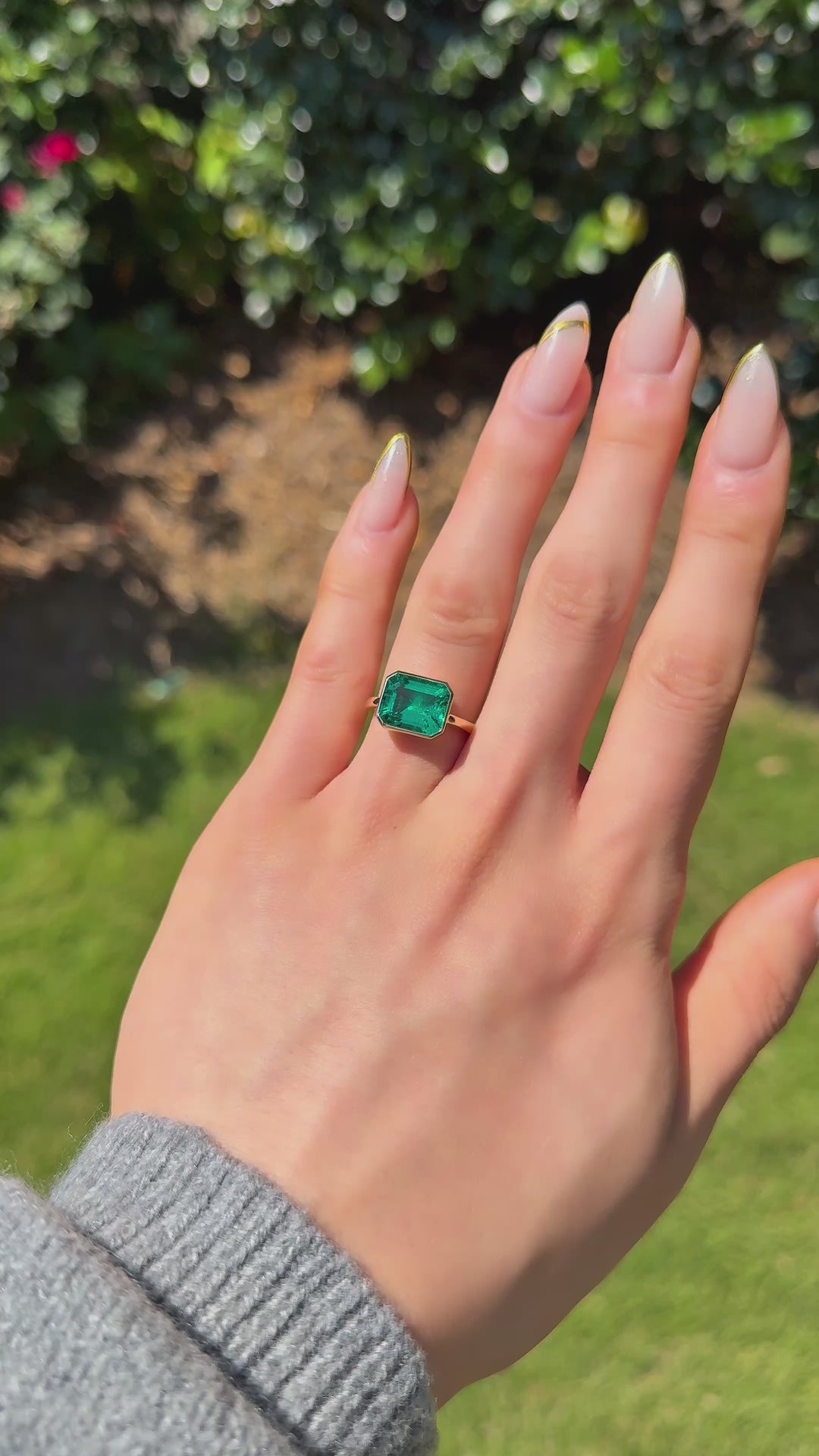 The Axis East-West emerald in 14K yellow gold — worn on the hand (outdoor light) [ld m=y shot=wear]