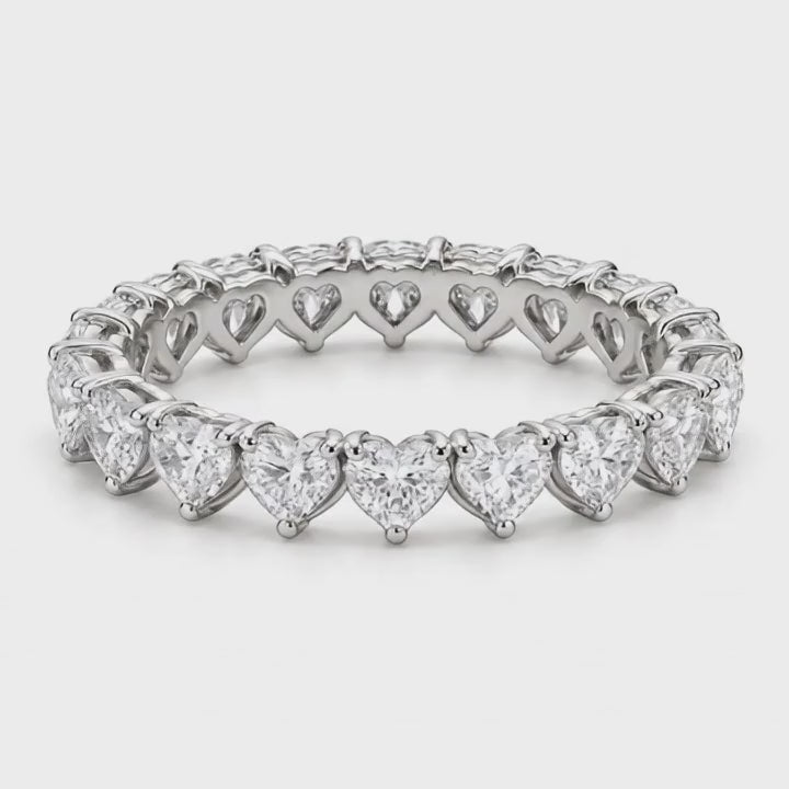 Heart lab-grown diamond eternity band in white gold turning on a white background