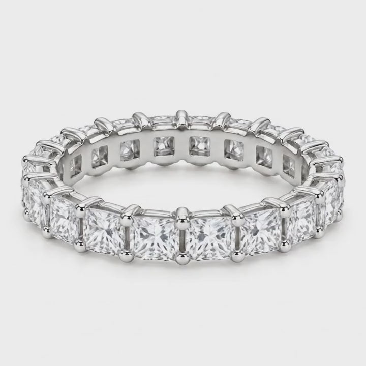 Princess lab-grown diamond eternity band in white gold turning on a white background