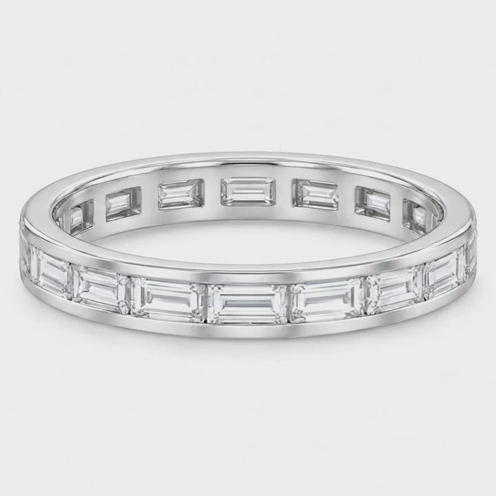 Baguette lab-grown diamond eternity band in white gold turning on a white background