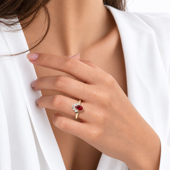 The Devotion — Pear Ruby Ring in 14K yellow gold, on the hand