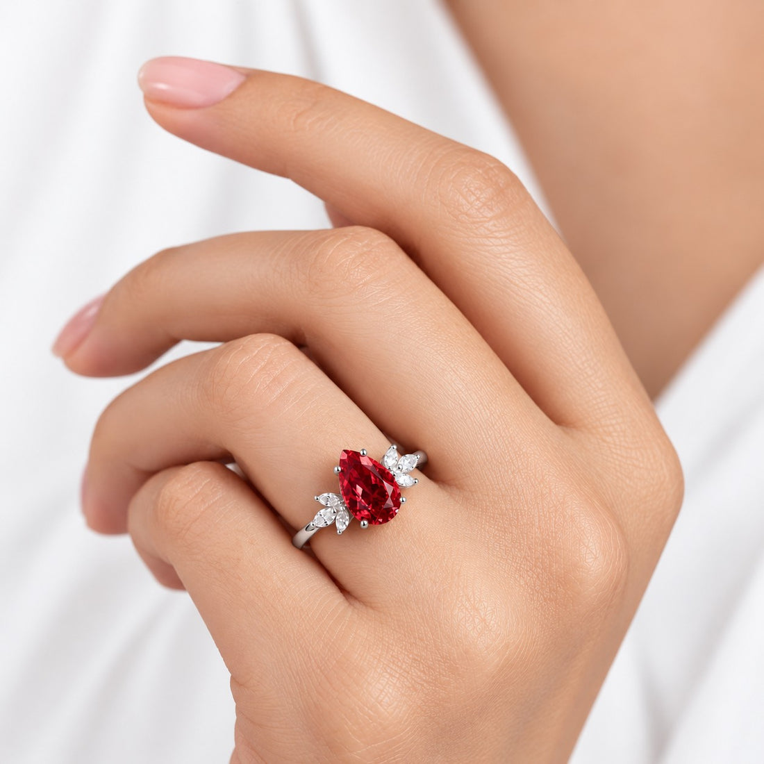 The Ember Laurel — Marquise Diamond Accent Pear Ruby Ring in 14K white gold, on the hand