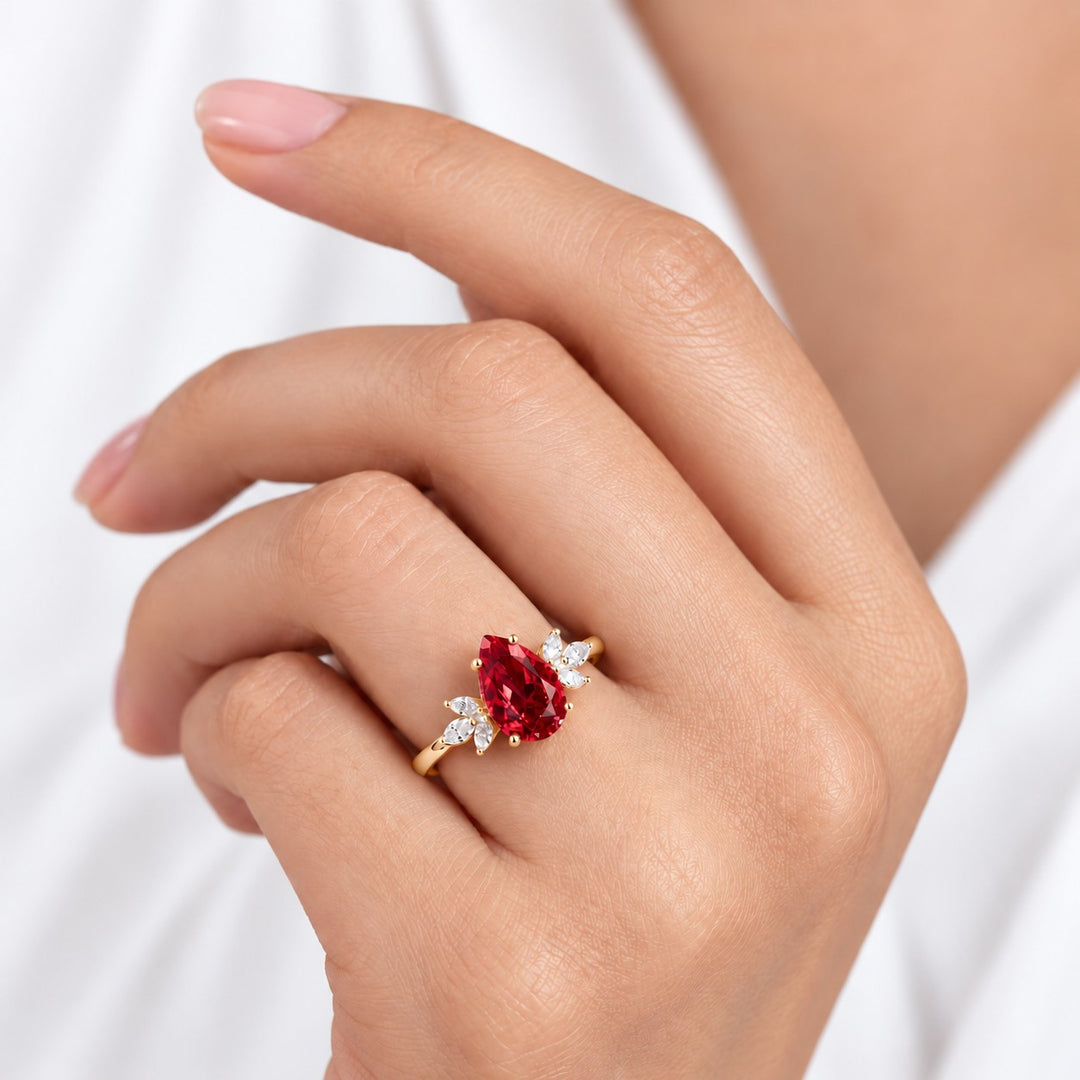 The Ember Laurel — Marquise Diamond Accent Pear Ruby Ring in 14K yellow gold, on the hand