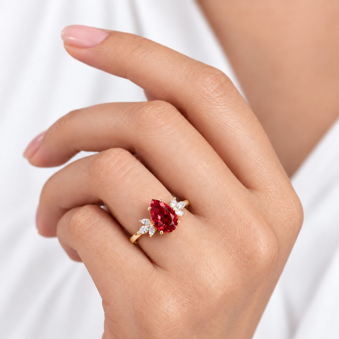 The Ember Laurel — Marquise Diamond Accent Pear Ruby Ring in 14K yellow gold, on the hand