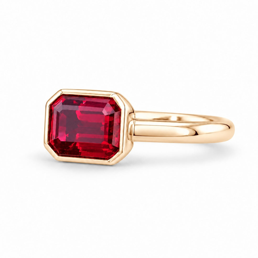 The Axis — East–West Bezel-Set Ruby Ring in 14K yellow gold, three-quarter view