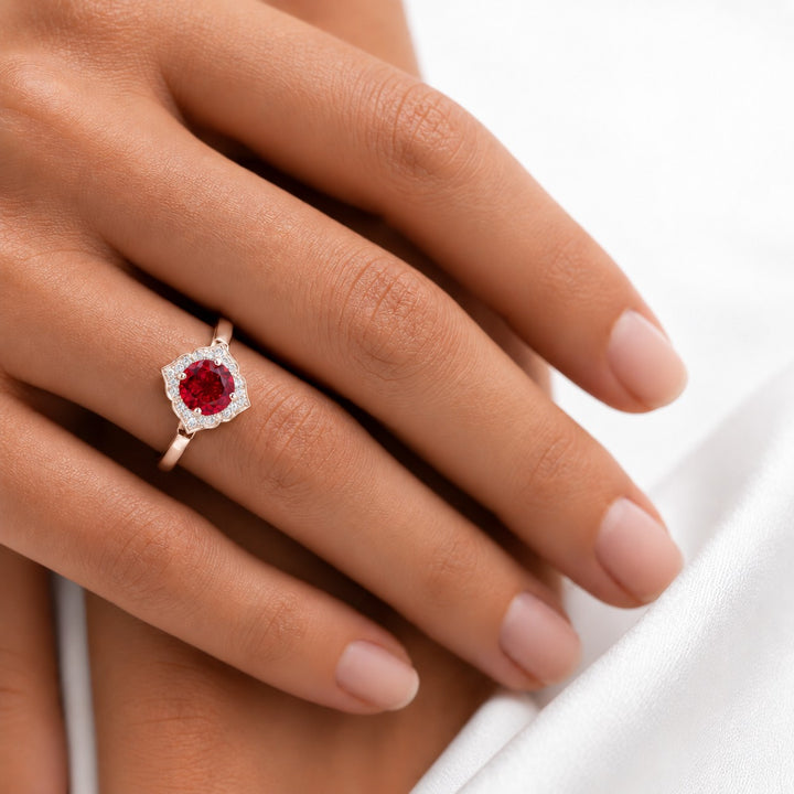 The Valencia — Vintage Diamond Halo Ruby Ring in 14K rose gold, on the hand