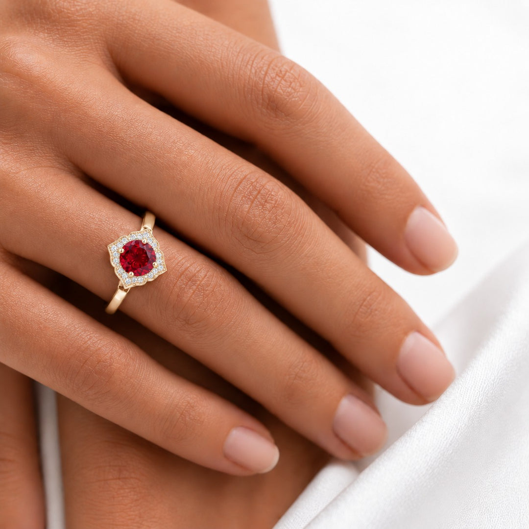 The Valencia — Vintage Diamond Halo Ruby Ring in 14K yellow gold, on the hand