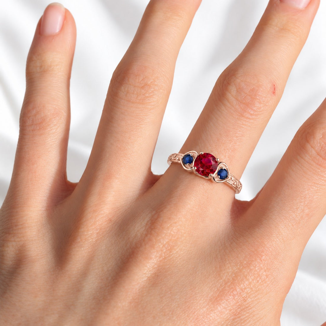 "Ruby & Sapphire" Three-Stone Ring in rose gold, on the hand