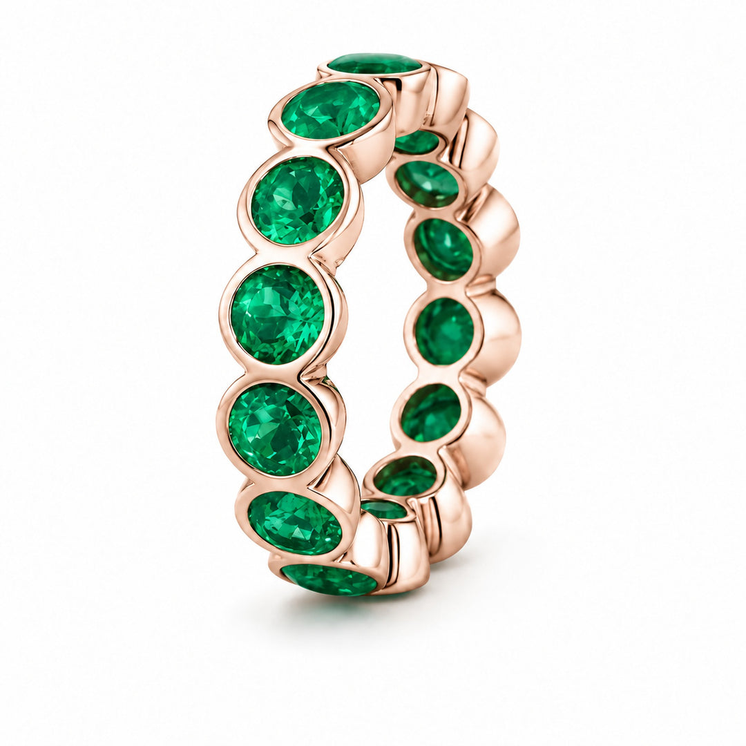 Round Colombian Emerald Bezel-Set Eternity Band in 14K rose gold, angle view