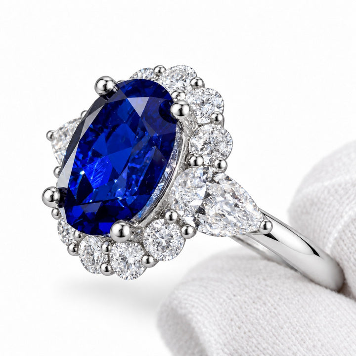 The Modified Diana — Diamond Halo Oval Blue Sapphire Ring in platinum, detail view