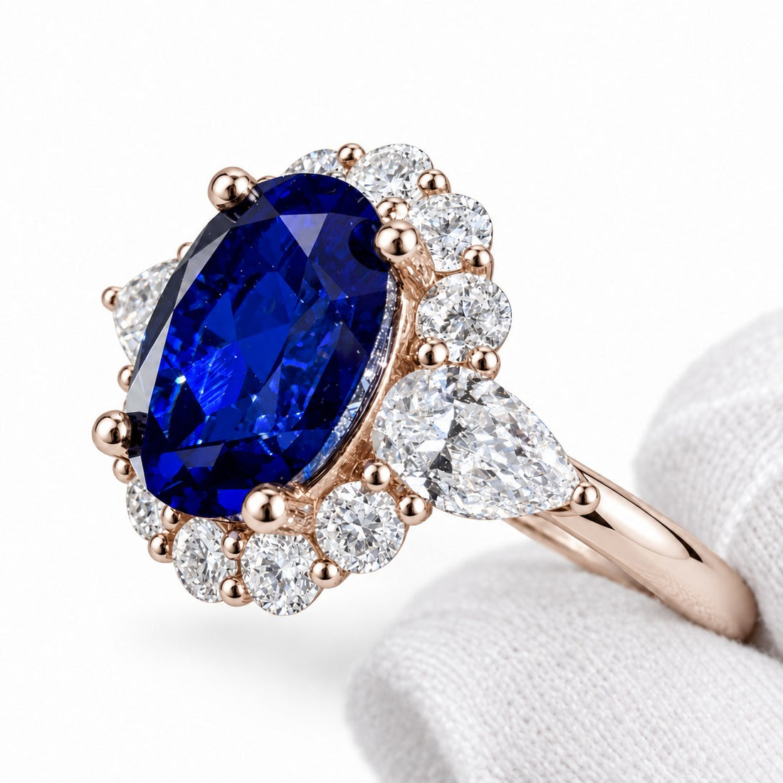 The Modified Diana — Diamond Halo Oval Blue Sapphire Ring in 14K rose gold, detail view