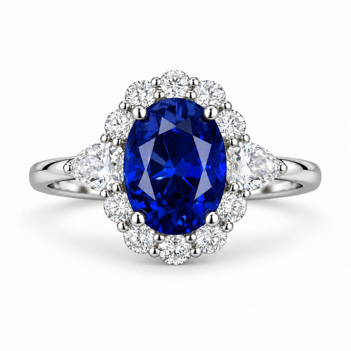 The Modified Diana — Diamond Halo Oval Blue Sapphire Ring in platinum, front view