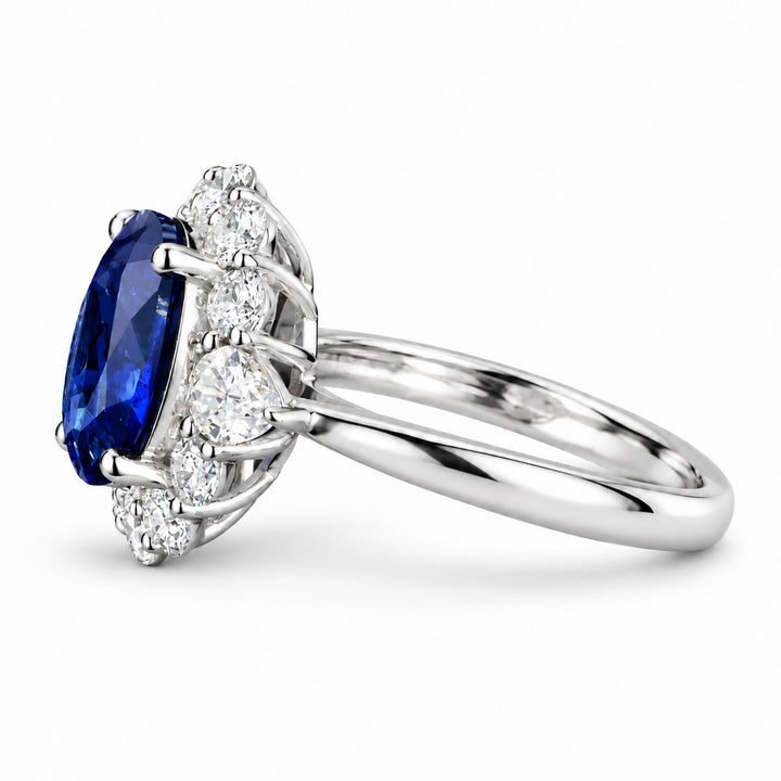The Modified Diana — Diamond Halo Oval Blue Sapphire Ring in platinum, side view