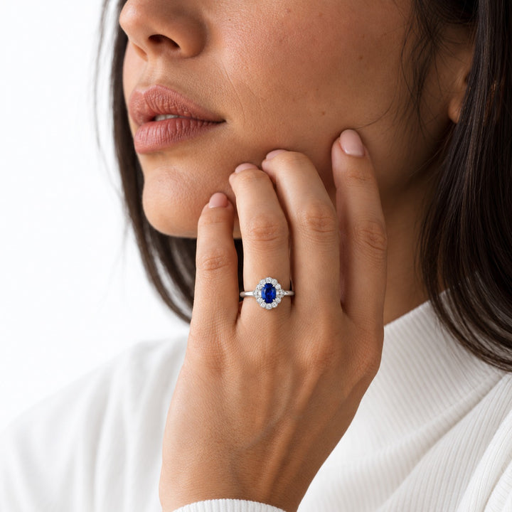 The Marielle — Petite Sapphire Halo Ring in 14K white gold, worn on hand