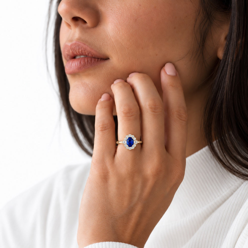 The Marielle — Petite Sapphire Halo Ring in 14K yellow gold, worn on hand