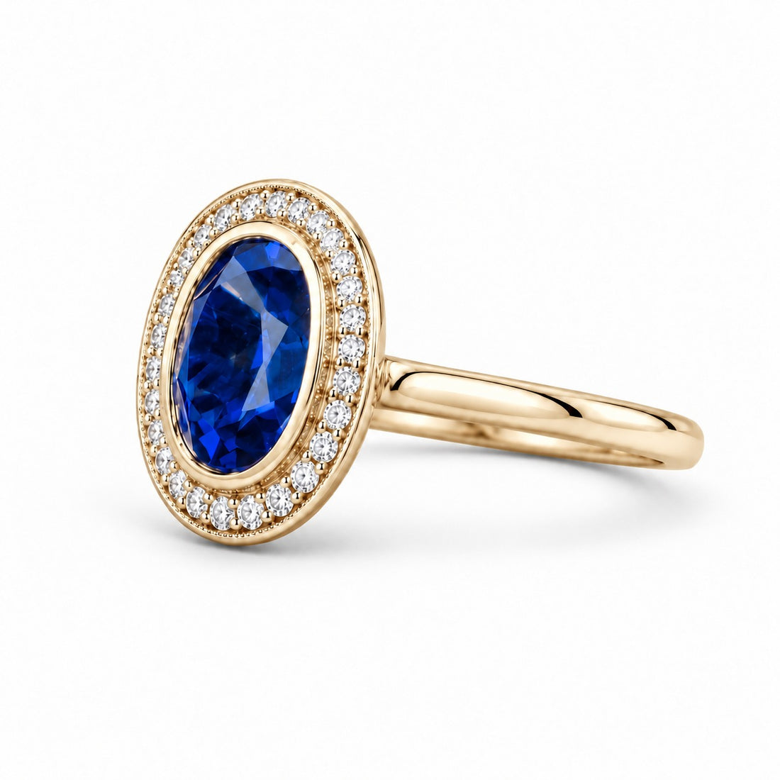The Celine vintage lab sapphire halo ring in 14K yellow gold, angled view