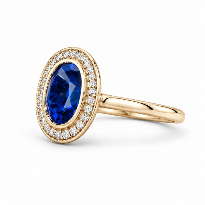 The Celine vintage lab sapphire halo ring in 14K yellow gold, angled view