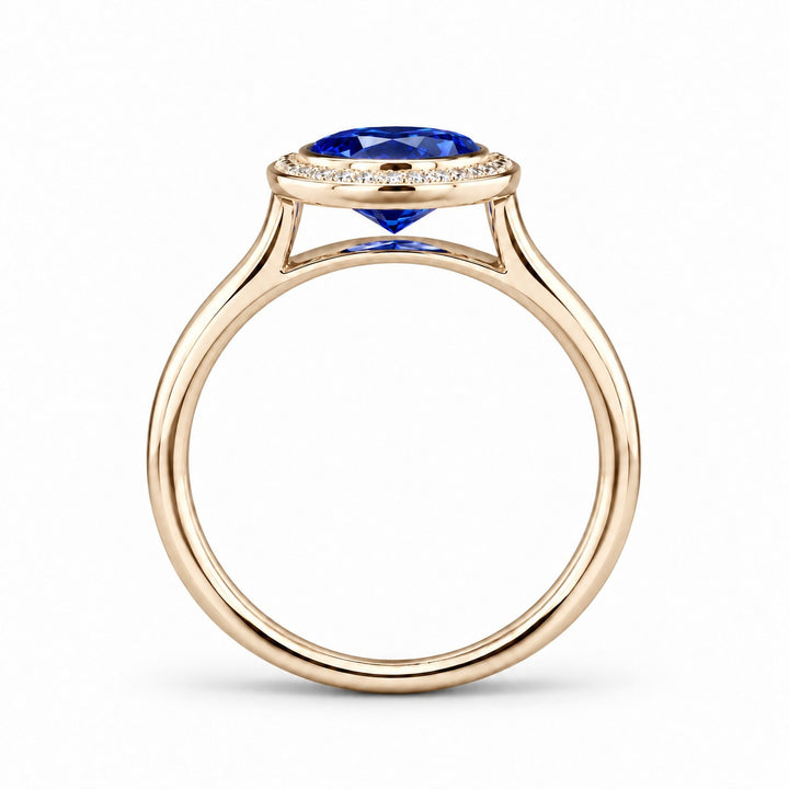 The Celine vintage lab sapphire halo ring in 14K yellow gold, profile view